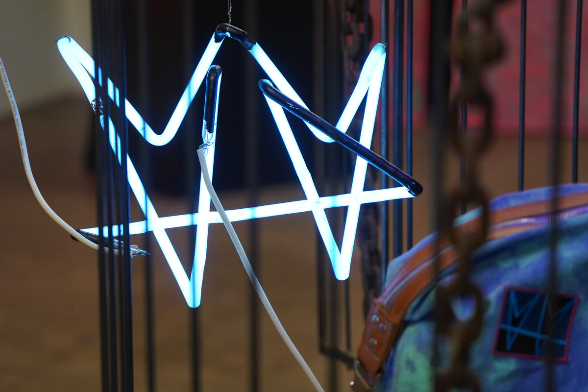 Close view of blue neon crown tubing and visible metal structure in The Cage by not.travis