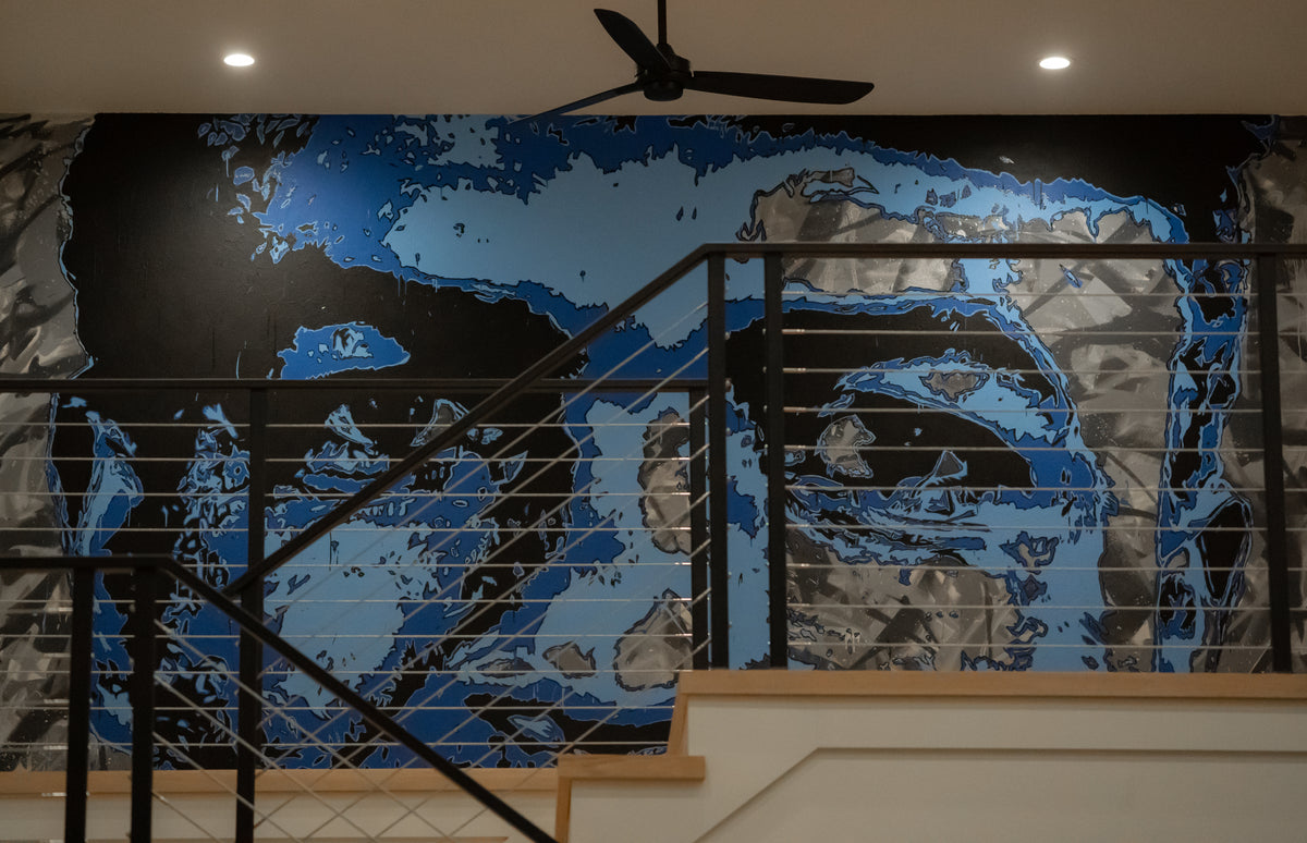 Blue and black Jackie Robinson mural across an interior stair wall