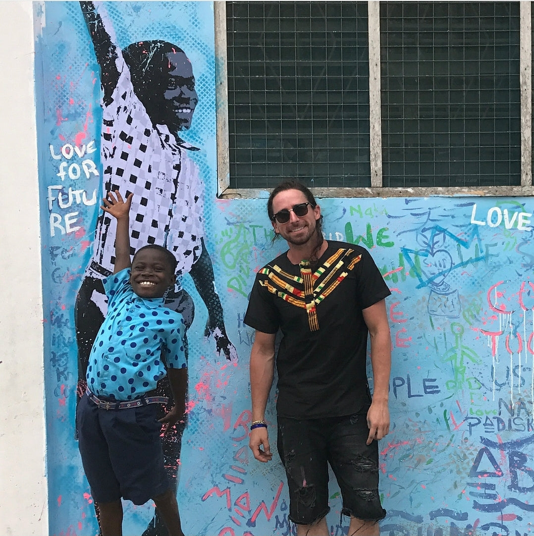 not.travis and a workshop participant beside the collaborative Project Ghana mural at Challenging Heights.